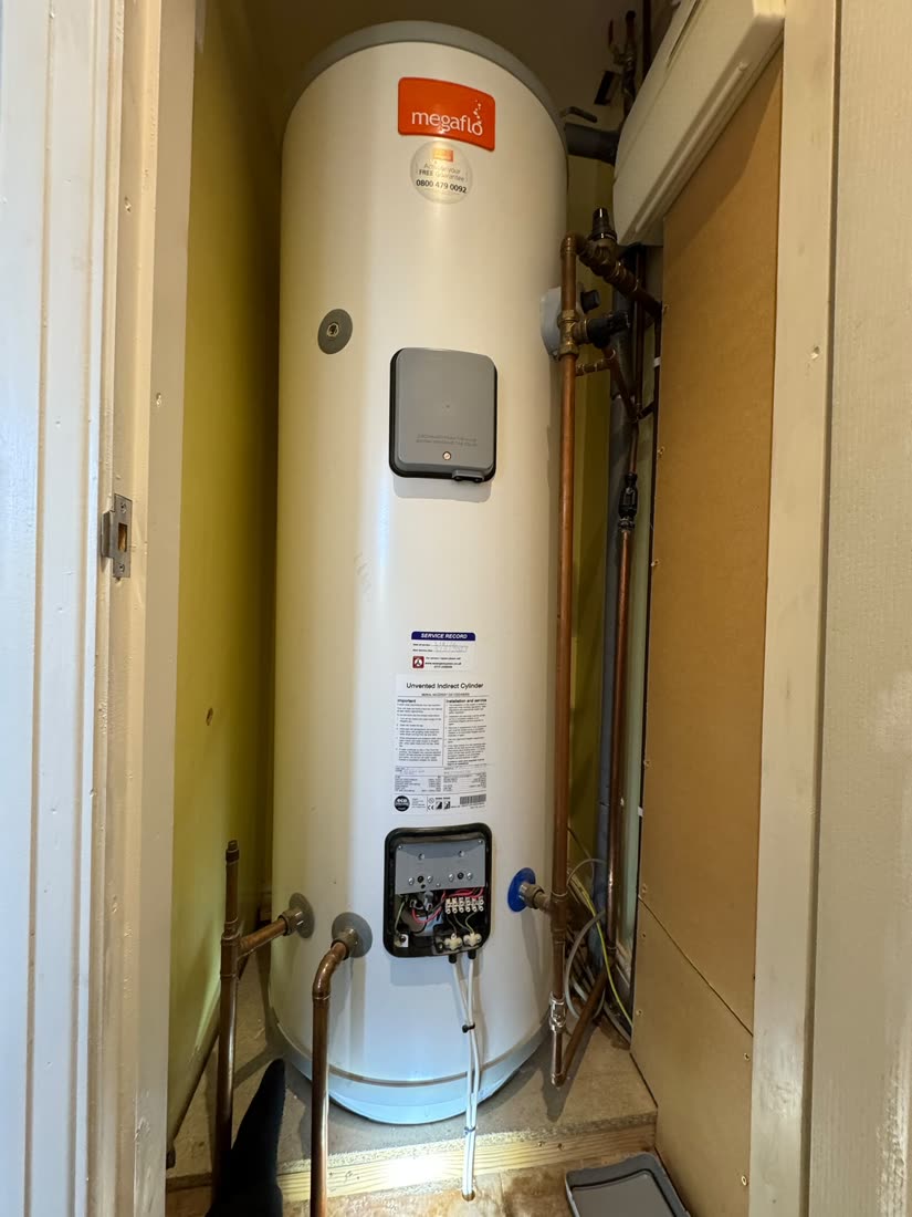 Megaflo unvented hot water cylinder being serviced in a Harrogate airing cupboard by a G3-qualified engineer