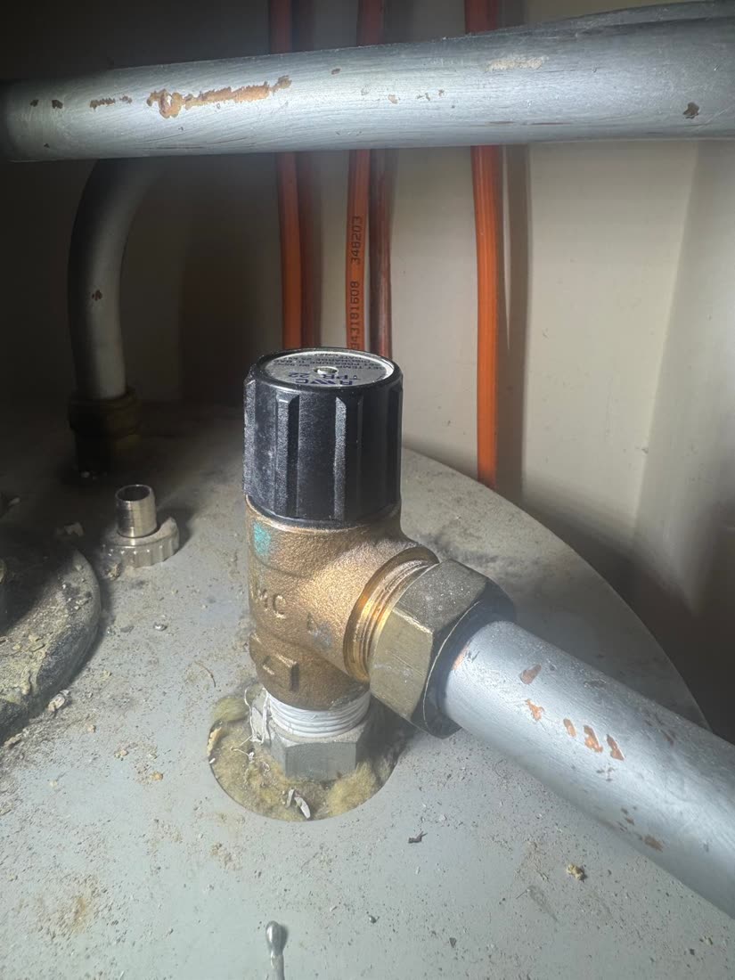 Temperature and pressure relief valve and its discharge pipe on an unvented hot water cylinder, checked during a service